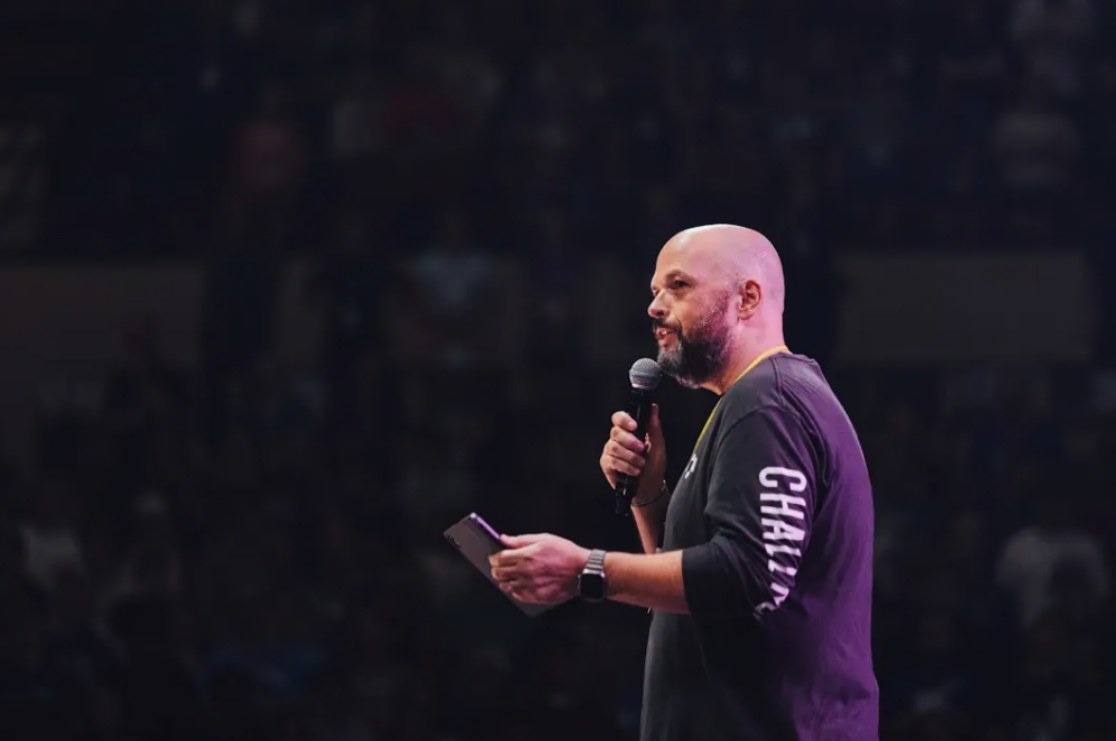 Brandon speaking with a microphone
